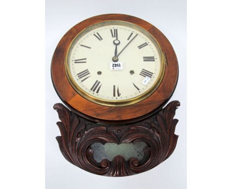 An Early XX Century Drop Bottom Wall Clock, in a stained mahogany carved case, with eight-day movement, the white enamel dial