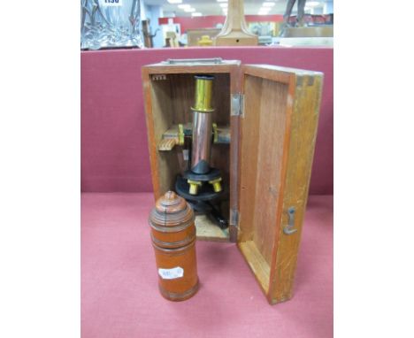 A Late XIX Century Small Extending Brass Telescope, in a turned treen box; A Travelling Lacquered Brass and Iron Microscope, 