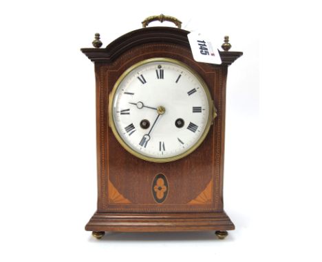 An Edwardian Mahogany Inlaid Mantle Clock, of rectangular form with stepped base and bun feet, carrying handle and finials to