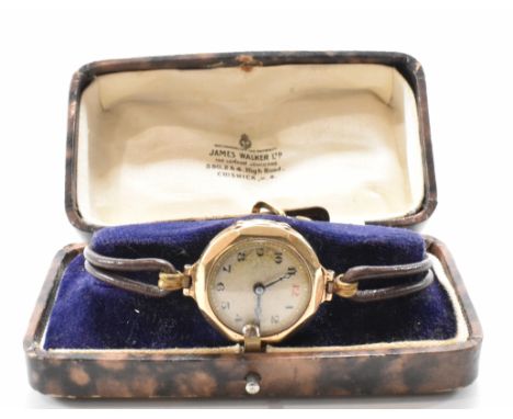 A hallmarked 9ct gold wrist watch. The watch having a round face with arabic numerals to the chapter ring, set within a 9ct g