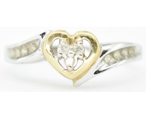 A hallmarked 9ct gold and diamond heart ring. The ring set with a diamond cluster within a yellow gold heart to diamond set s