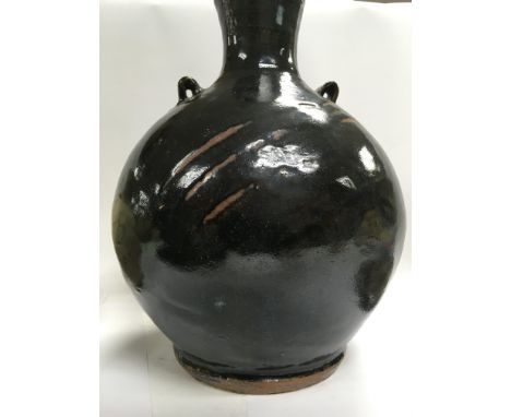 A collection of stone ware art pottery comprising twin handle blue and black glazz vase 30 cm Two stone ware vase with celado