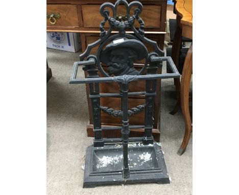 A cast iron stick stand the back the frame decoration incorporating a side profile.