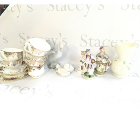 A collection of ceramics including a Royal Doulton Sit figure, Nao swans and a large collection of plates including Paragon B