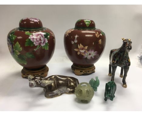 A collection of cloisonnÃ© figures and vases with stands and some jade figures.