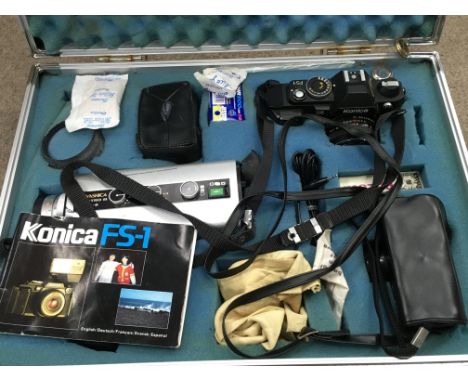 A cased Konica FS-1 camera with various accessories including a Yashica Electro 8 LD-6. Postage category C