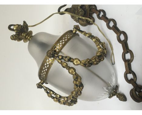 A brass and glass hall lantern with raised brass garlands.no obvious damage with chain and ceiling rose and a pair of unusual