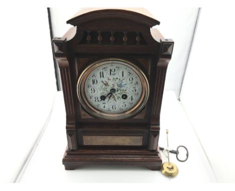 A Victorian mantle clock with pendulum. Winds and runs. 30cm tall by 19cm wide.