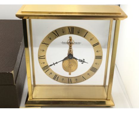 A Jaeger LeCoultre mantle clock with own fitted box. Winds and runs. 16cm wide and 17cm tall. Postage D