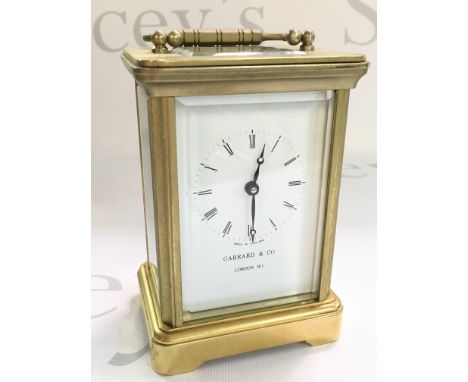 A brass Garrard & Co carriage clock, dimensions 6x8x12cm approximately. With key , seen working. this lot cannot be posted