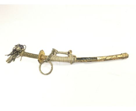 A miniature model of a Japanese wakizashi sword with scabbard, 23cm long. This lot cannot be posted