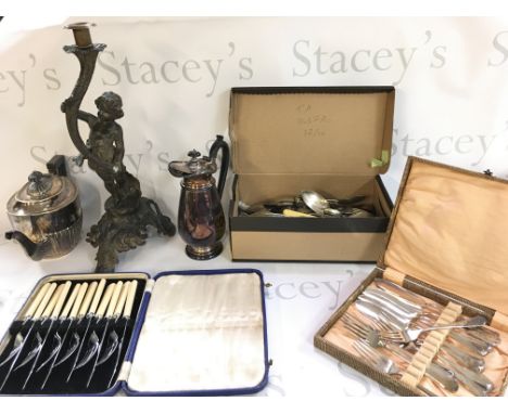 A Collection of silver plate including cutlery, a jug, teapot and a pewter candle stick figure. Postage category C
