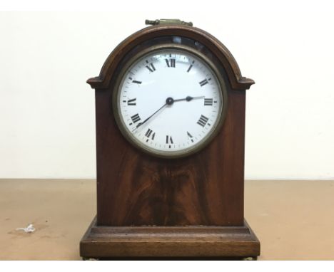A small mahogany Edwardian mantle clock with brass handle and enamel dial, this lot cannot be posted