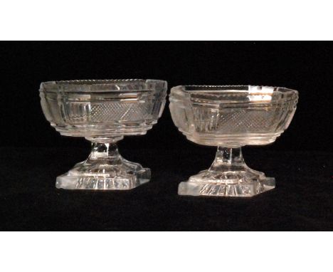 A pair of late Georgian table salts circa 1810, possibly Irish, with octagonal bowls decorated with panels of fine cut decora