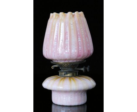 A late 19th Century Stevens & Williams oil lamp of mushroom form with brass gallery and fluted shade, both decorated in a mag