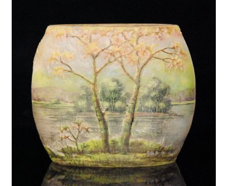 A small early 20th Century Daum landscape cameo glass vase of compressed ovoid form, cut with a tree lined lake scene enamell