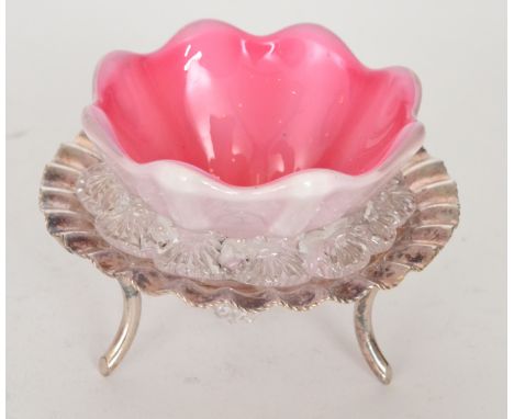 A late 19th Century Stourbridge glass table salt of fluted conical form cased in opal over pale pink and decorated with an ap