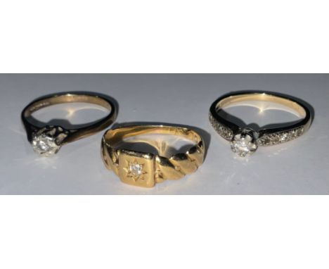 A 14ct gold diamond solitaire ring, illusion set, each shoulder accented with diamond chips, size Q/R, marked 585, 2.9g; an 1