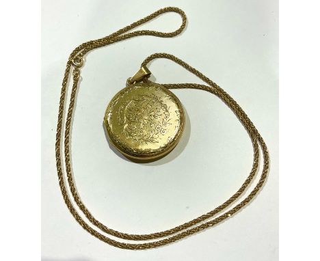An 18ct gold rope twist necklace and locket pendant, the necklace stamped '750' for 18ct gold, the locket engine turned and e