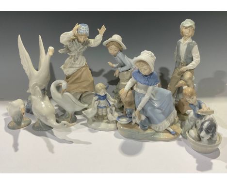 A Lladro figure, of a girl bathing a puppy; a collection of Nao figures and geese, etc (10) 