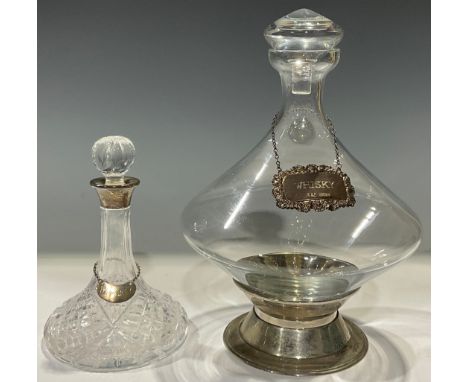 An Elizabeth II miniature cut glass ship's decanter, silver collar, 16cm, Birmingham 1984, with silver "Whisky" label, Birmin