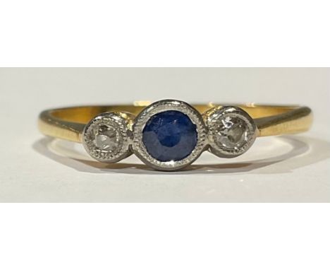 An 18ct gold three stone sapphire and diamond ring, platinum milled bezel, size R, 2.5g 