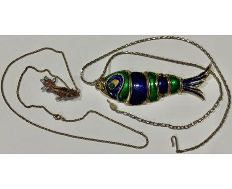 A silver and enamel reticulated fish pendant, 4cm, suspended from a base metal necklace chain; a larger enamelled fish pendan