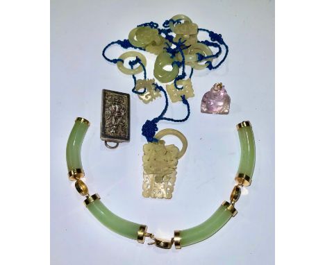 A Chinese jade pendant; a hardstone Buddha fob; a bangle (a/f); a silver brooch 