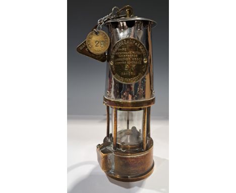 An Eccles miner's safety lamp, Prestwich's Patent Protector; a Markham Colliery pit check; another (3) 