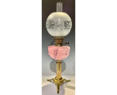 A brass oil lamp, opaque pink glass reservoir, Duplex twin burner, ovoid acid etched frosted glass shade, chimney, resting on