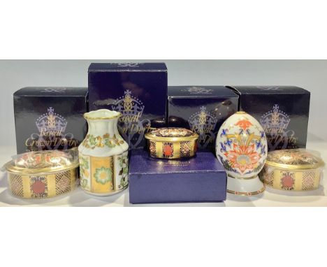 A set of three Royal Crown Derby 1128 pattern graduated oval trinket pots and covers, each boxed; a Royal Crown Derby Japan p