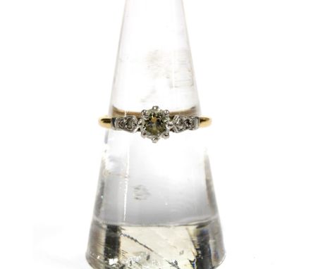 18ct gold diamond ring, the central bright cut diamond claw set in platinum with two smaller diamonds to each shoulder, insid