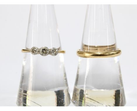 An 18ct gold three stone diamond ring with platinum setting together with a 14ct gold wedding band (2) 