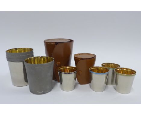 Two sets of Epns and enamel beakers, in tan leather travelling cases 