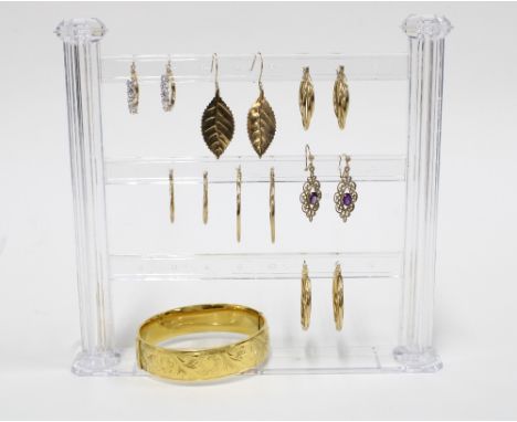 Six pairs of 9ct gold earrings and a pair of gold plated hoop earrings together with a gold plated bangle 