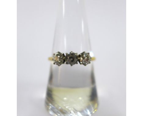 Diamond three stone ring, claw set with three old round-cut diamonds, the yellow  gold band stamped 18ct 