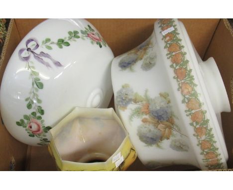 A box with three vintage glass light shades: a smaller yellow one decorated with rural scene and two larger of white glass, f