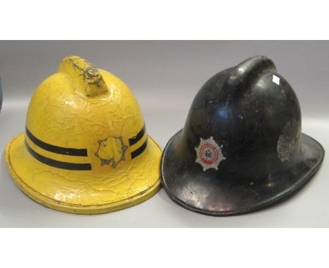 Two vintage fireman's helmets, one marked Swansea Fire Brigade. (2)(B.P. 21% + VAT) 