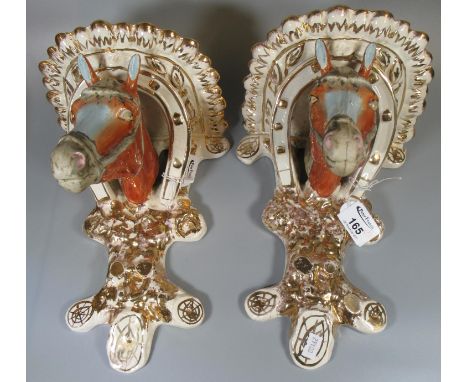 Pair of ceramic wall brackets in the form of horses heads with horseshoe design. (2)(B.P. 21% + VAT) 