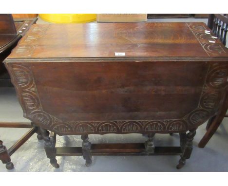 Early 20th Century oak barley twist gate legged table having moulded shaped and carved top, standing on casters.(B.P. 21% + V