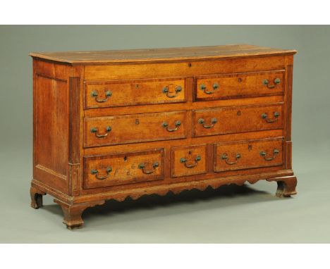 A George III oak and mahogany crossbanded Lancashire mule chest, with four false drawers beneath the lift up top and fitted w