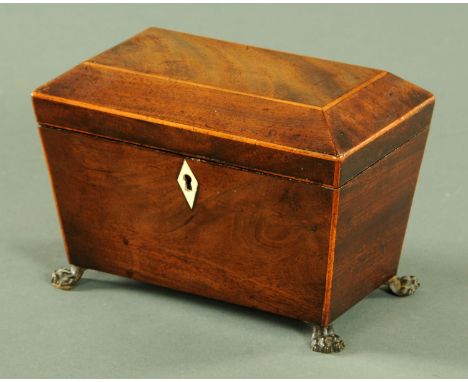 A George III mahogany tea caddy, with boxwood strung edge and two interior compartments, raised on embossed brass paw feet.  
