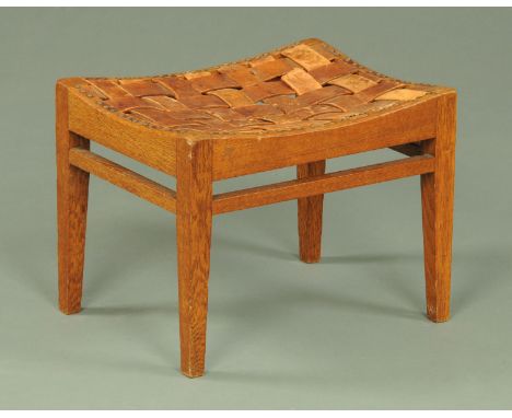 An Arthur Simpson of Kendal stool, oak, with latticework leather top and tapered legs of square section.  Width 40.5 cm. COND