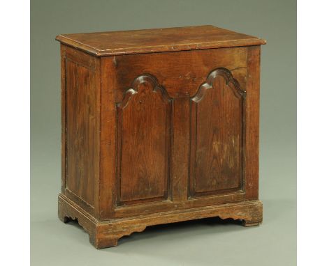 An antique oak coffer, narrow form, with two arched panels and raised on bracket feet.  Width 72 cm. 