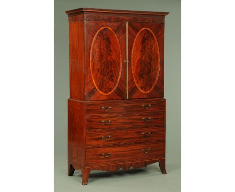 A George III mahogany gentleman's press, with moulded cornice above a pair of panelled cupboard doors opening to later shelve