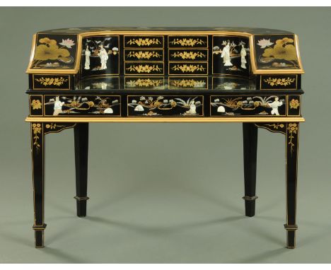 A chinoiserie lacquered Carlton house style desk, decorated in relief with Chinese figures and painted with lilies and birds,