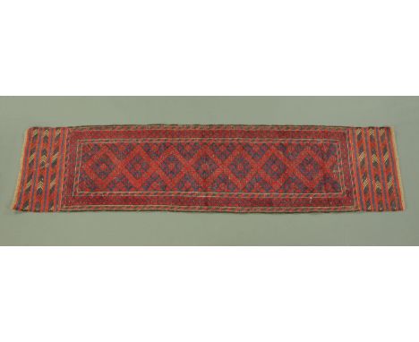 An Eastern fringed runner, with centre rectangular panel and three line border, 250 cm x 60 cm.