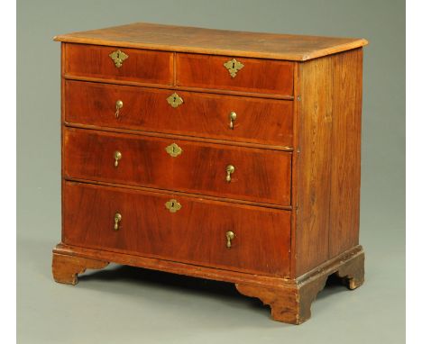An 18th century walnut chest of drawers, with well figured top and moulded edge above two short and three long graduated draw