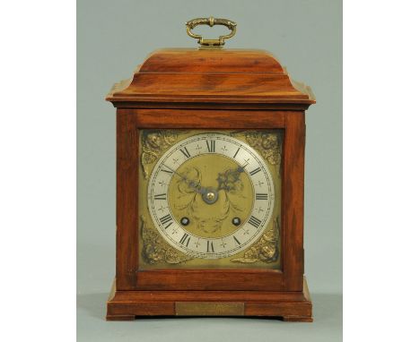 An early 20th century walnut bracket clock, having a square brass dial with silvered chapter ring, retailed by M.H. Tilley an
