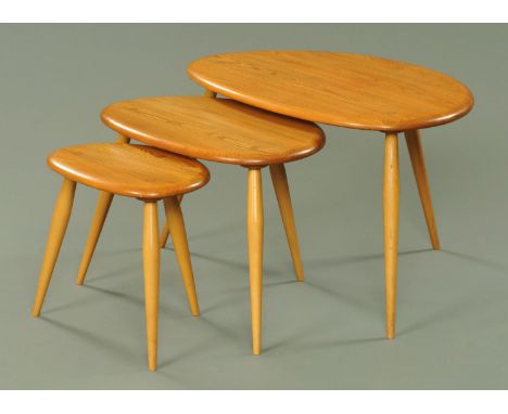 A nest of three Ercol light elm "pebble" tables (see illustration).